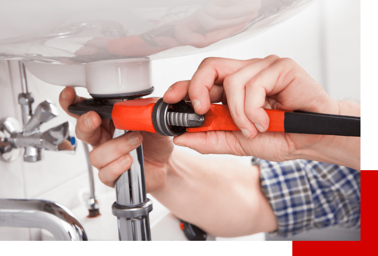Plumber fixing sink with orange wrench
